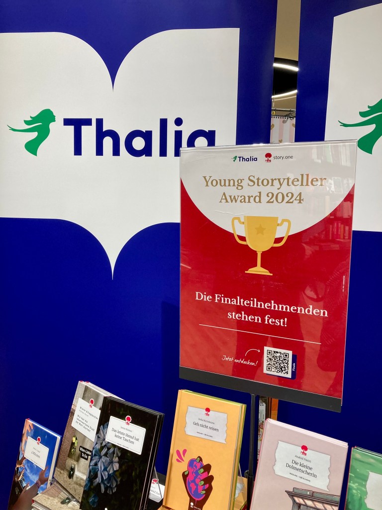 A display of books with signs and posters.