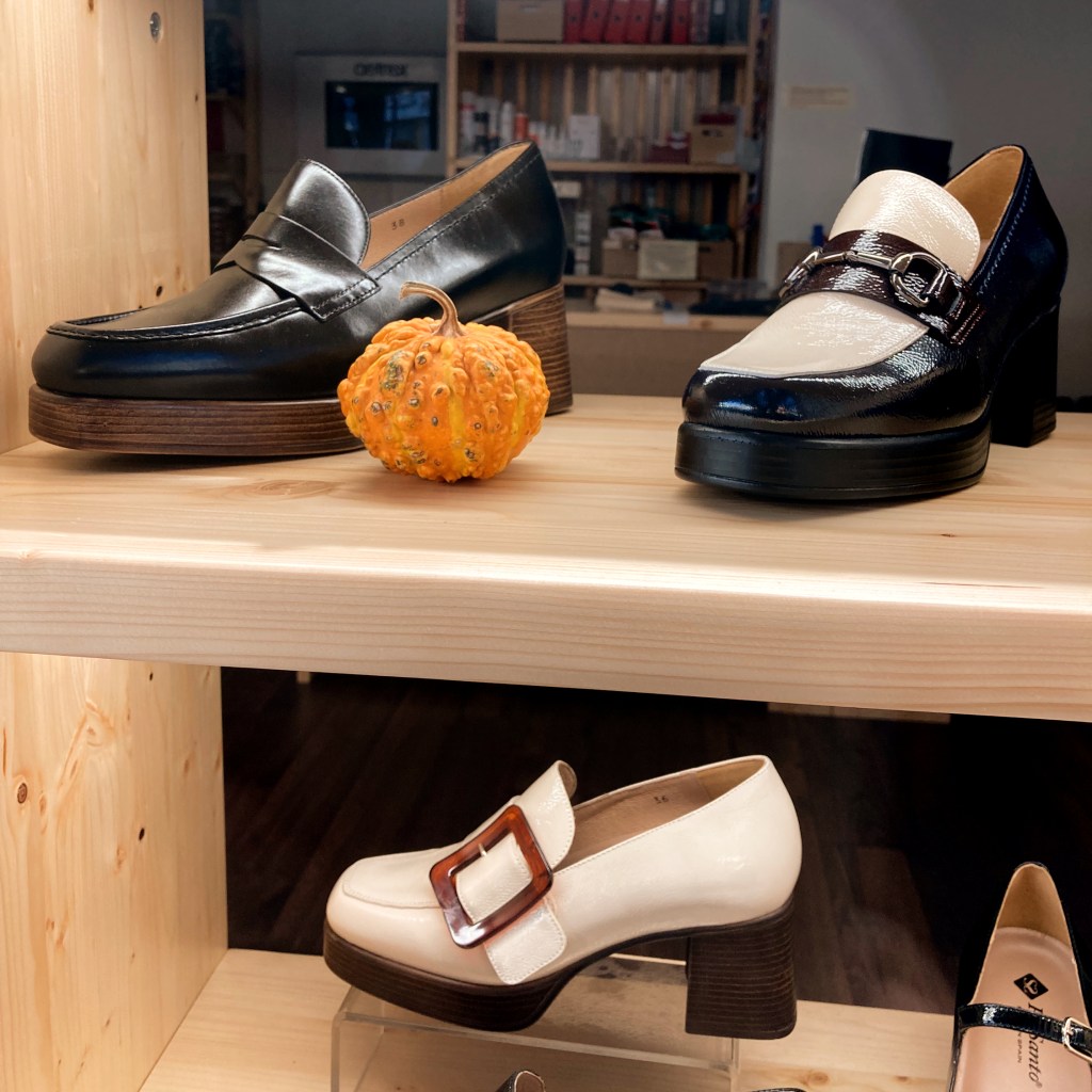 Shoes on a shelf with pumpkin