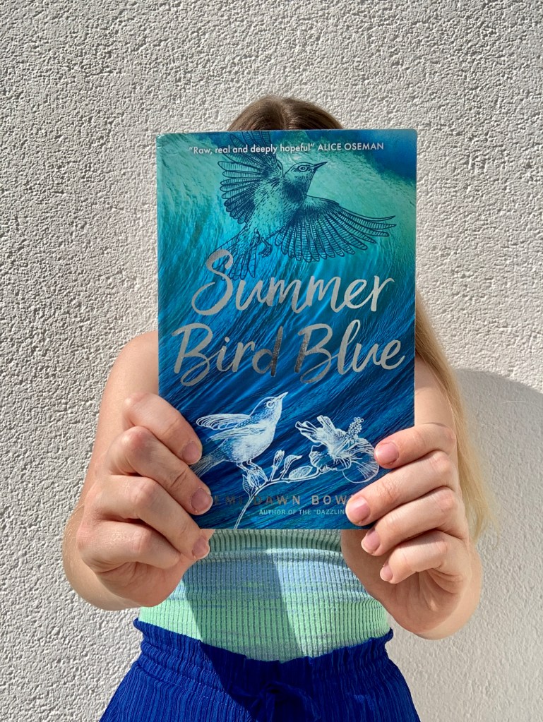 Person holds book towards you so that the book fills nearly the whole image