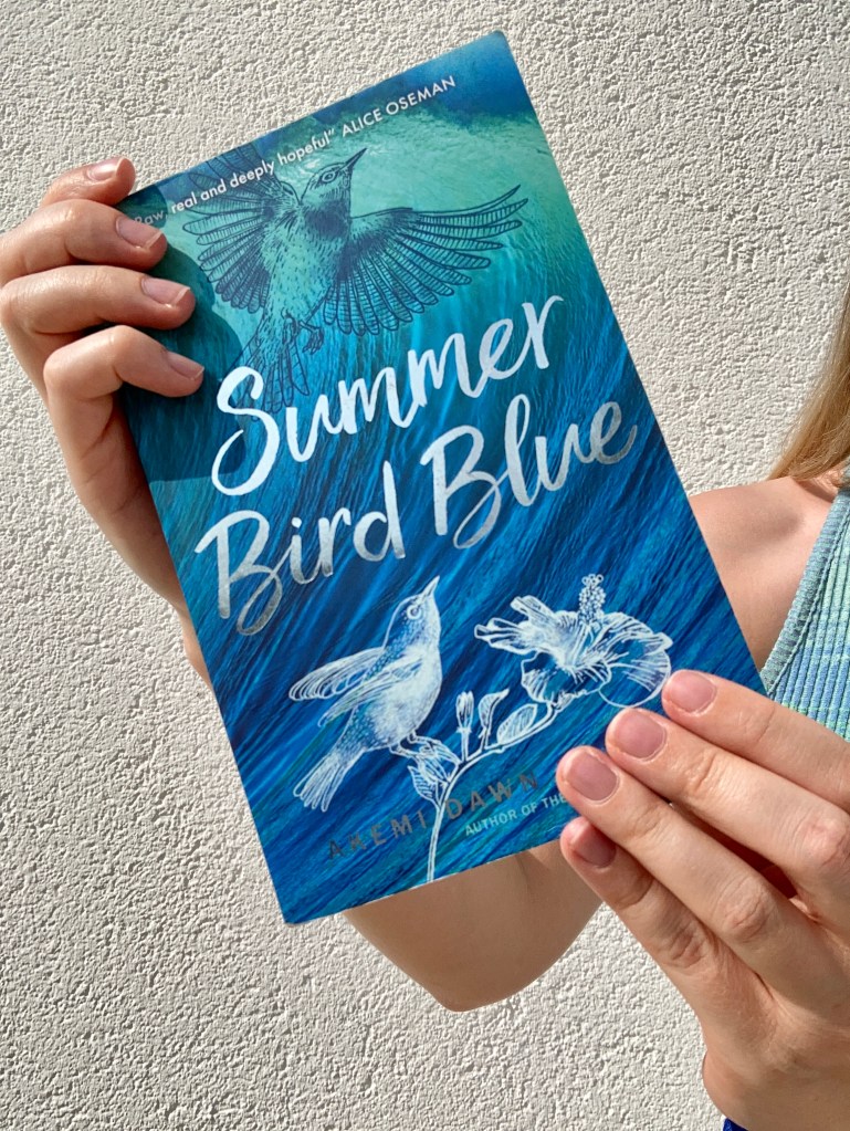 Close-up of the book cover that shows blue green ocean and two birds
